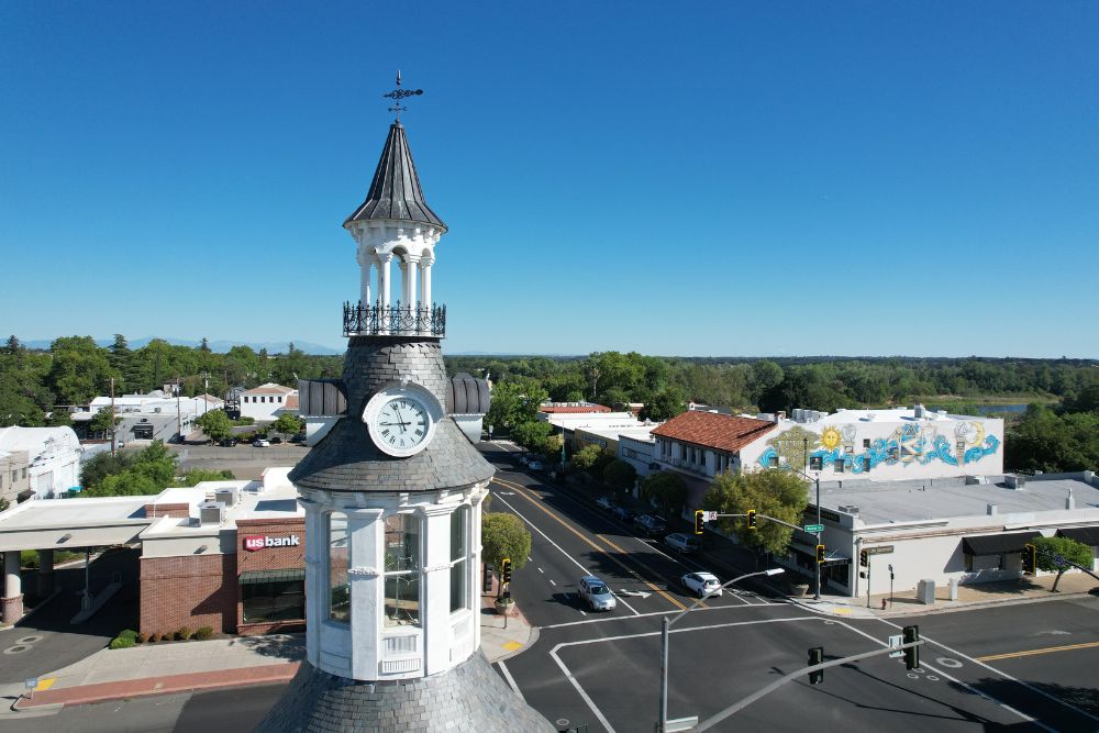 an aerial view of a town with a clock tower